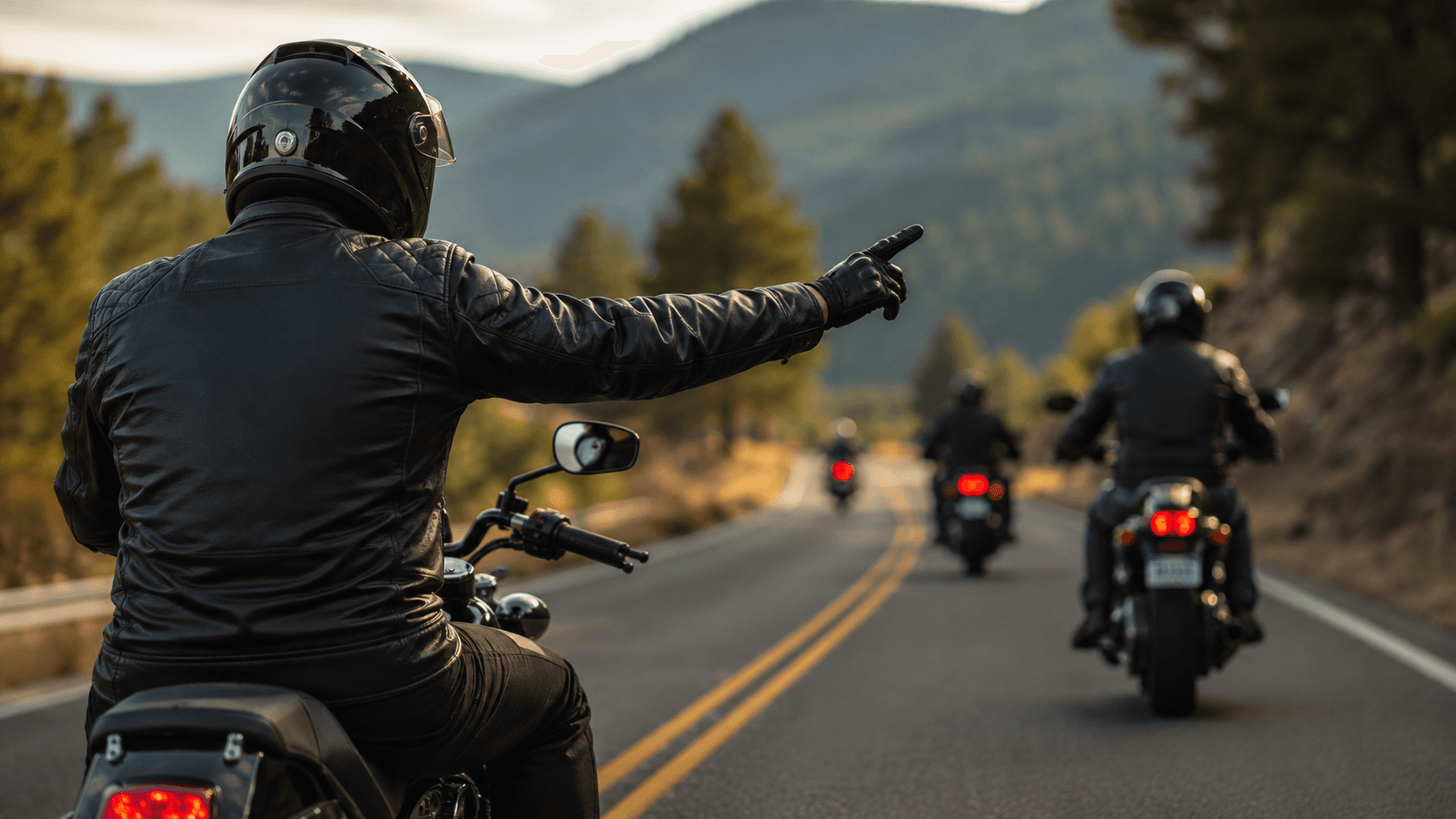 A rider raising a gloved hand above their helmet to signal to the riders behind them